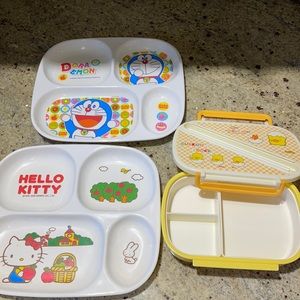 2 plates with dividers and a bento box